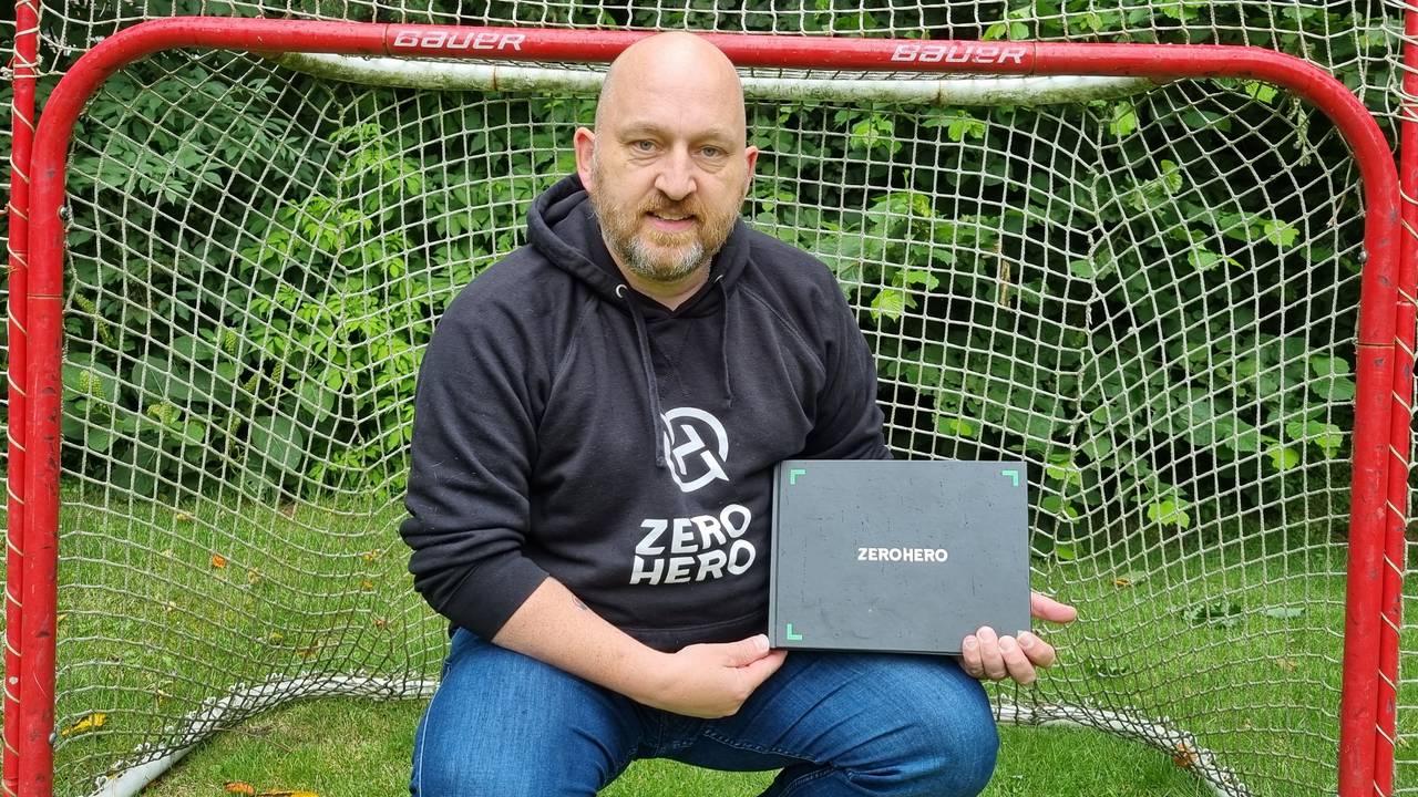 Martijn Buurman, oprichter van ZEROHERO, zittend in een goal met het ZEROHERO-boek